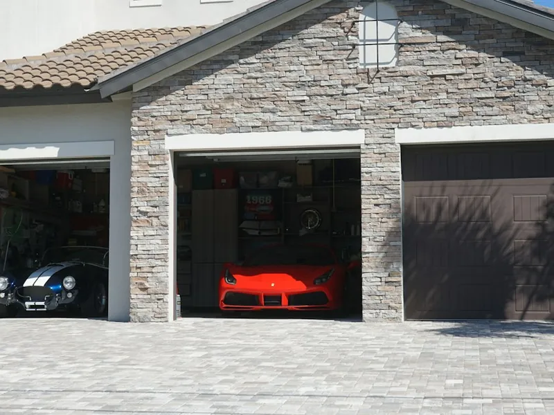 Three-car garage with two doors opened by automatic garage door openers